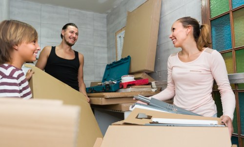 Professional packers handling moving boxes in Storage Wimbledon