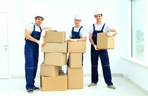 Movers disassembling large furniture pieces for storage removal in Wimbledon